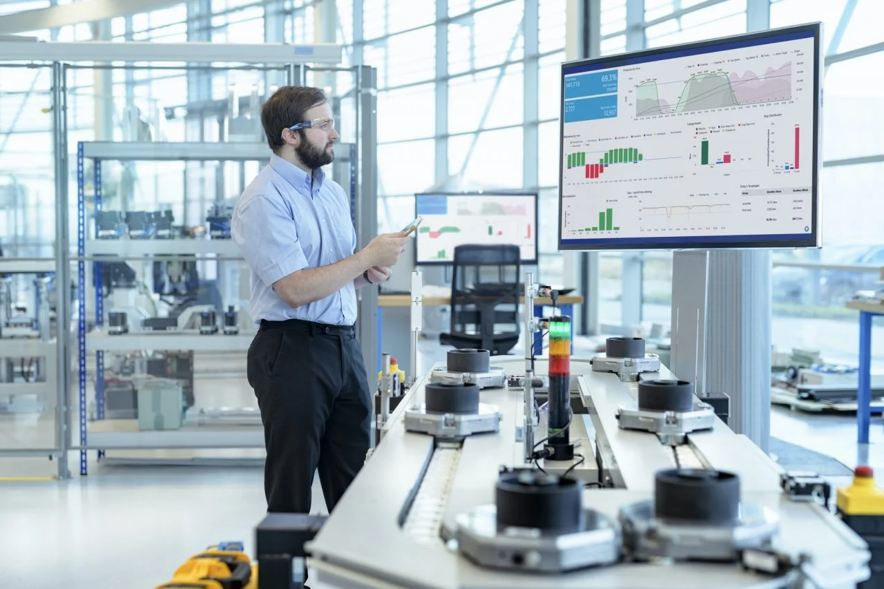 engineer testing a robotic production simulator in robotics research facility 1